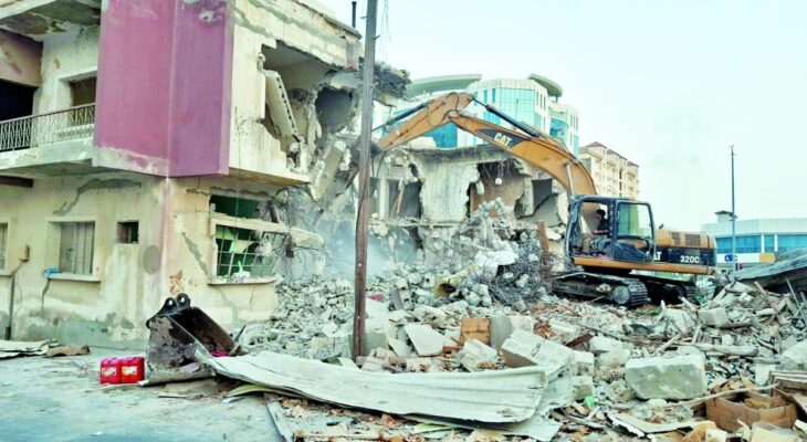 Doha Municipality demolition team overseeing the removal of a dilapidated building in New Doha
