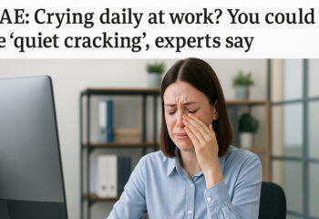 Employee sitting alone at desk struggling with workplace stress