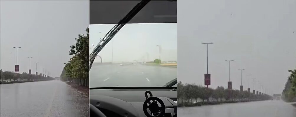 Dubai road flooded during heavy rainfall with low visibility